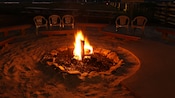 Guests enjoying a guitar player around a campfire at Disney's Fort Wilderness Resort