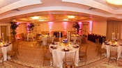 Fisheye view of banquet room with round tables set formally