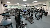 Disney's Vero Beach fitness room with workout equipment, mirrored walls and TVs