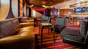 A lounge with a row of sofas opposite easy chairs with a cocktail table