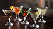 5 glasses containing various types of martinis