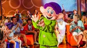 Children and adults applaud for Dopey in a kids lounge
