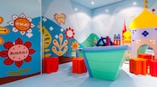 A play area with 3 dimensional decorations of the small world attraction, at Its a Small World Nursery