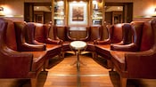 Six large leather wing chairs face each other in a half circle