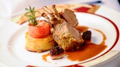 Oregano and parmesan crusted rack of lamb with shallots, tomatoes, potato torta and a delicate sauce