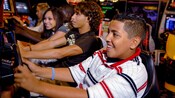 Kids play high tech video games in the Quarter Masters arcade on the Disney Magic
