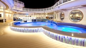 Open area at night with interlocking circular pool and walk up Cove Bar