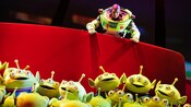 Buzz Lightyear encounters a large bin filled with 3 eyed alien toys