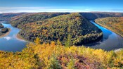 A river winds through hills covered in trees