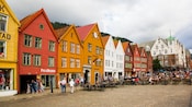 VIbrant 4 story buildings with siding on a busy cobblestone street