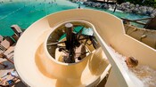 A girl slides down a waterslide in Castaway Cay