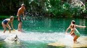 Four kids splash around in a lake in Cozumel Mexico