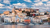 Private yachts are docked along the coast of Ibiza City, a town nestled on the islands slopes
