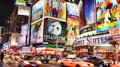The flashy marquees of successful musicals line Broadway