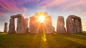 The sun peeking through Stonehenge