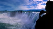 Rushing waterfalls and hills with greenery