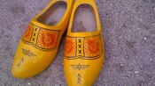 A pair of wooden Dutch clogs painted in folk designs