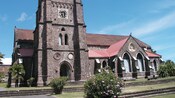 The crenellated stone tower of Saint George's Anglican Church in Saint Kitts, West Indies