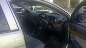 An open car door featuring the interior of a Mitsubishi with the steering wheel on the right side