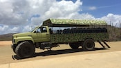 A large safari truck on a dirt road