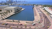 Cars travel the roadways along Cartagenas Caribbean waterfront with modern buildings in the background
