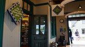 The entrance to a charming gift shop features a diamond shaped wooden sign that reads The Anne of Green Gables Store