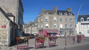 People near shops and buildings in a town