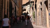 A crowded alleyway of shops in old buildings