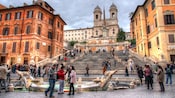 Tourists by the fountain in front of the Spanish Steps in Rome