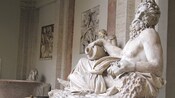 A reclining statue of a bearded river god holding a vase