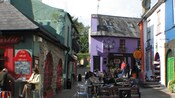 A collection of shops and a seating area full of people