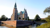 A moat surrounds the brick exterior of Rosenborg Castle