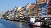 Row buildings line the dock of a canal filled with boats