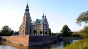 A moat surrounds the brick exterior of Rosenborg Castle