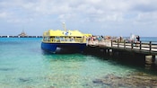 A catamaran docked at a crowded pier