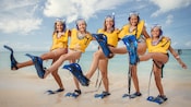 A woman and her 4 daughters form a mock Can Can line wearing flippers and snorkeling gear