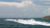 3 Guests on WaveRunners zip across the water at Castaway Cay