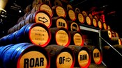 A display of stacked beer barrels labeled Roar of Raw Heat