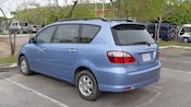 Side and back view of a late model, 4 door minivan with hatchback