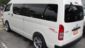 Back and side view of late model van with sliding glass door and tinted windows