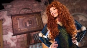 A woman with long curly locks in a princess costume