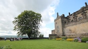 People standing on a lawn outside Stirling Castle