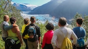 A group of people stare out at an ice berg