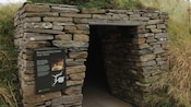 Grass-covered stone entrance to one of Skara Brae's prehistoric dwellings