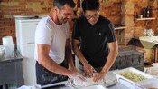 2 men in a farmhouse kitchen preparing pasta dough