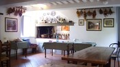 A long table with wood cutting boards, knives and bowls in place for pasta making