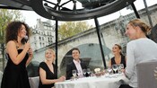 Diners entertained by a singer aboard a boat.