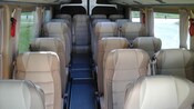 A minibus with single seats on one side and double seats on the other side