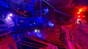 A subterranean playground area featuring trampoline like nets