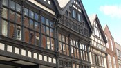A row of tightly packed buildings featuring multiple windows